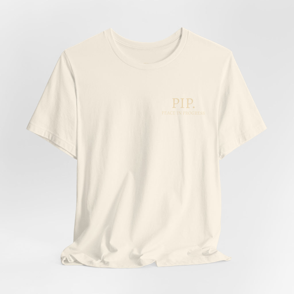 Peace In Progress Tee — PIP. Crew Neck Short Sleeve T‑Shirt