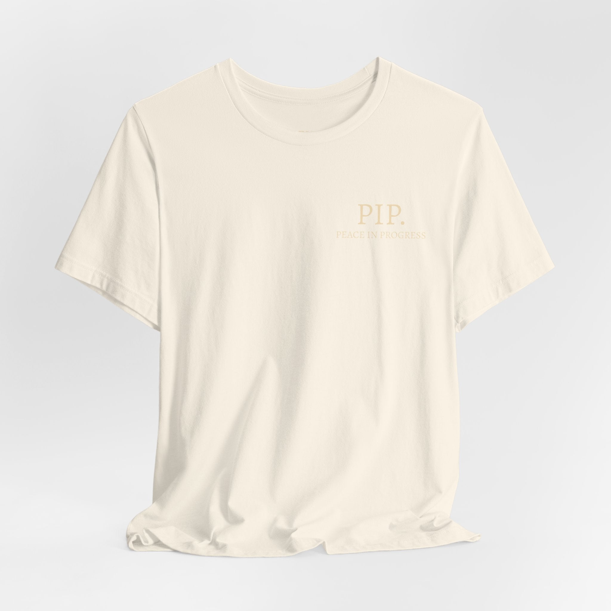 Peace In Progress Tee — PIP. Crew Neck Short Sleeve T‑Shirt