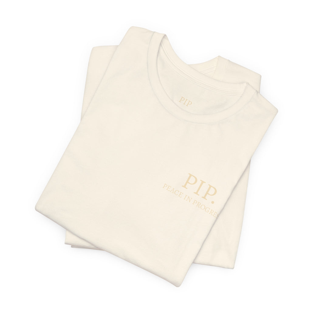 Peace In Progress Tee — PIP. Crew Neck Short Sleeve T‑Shirt